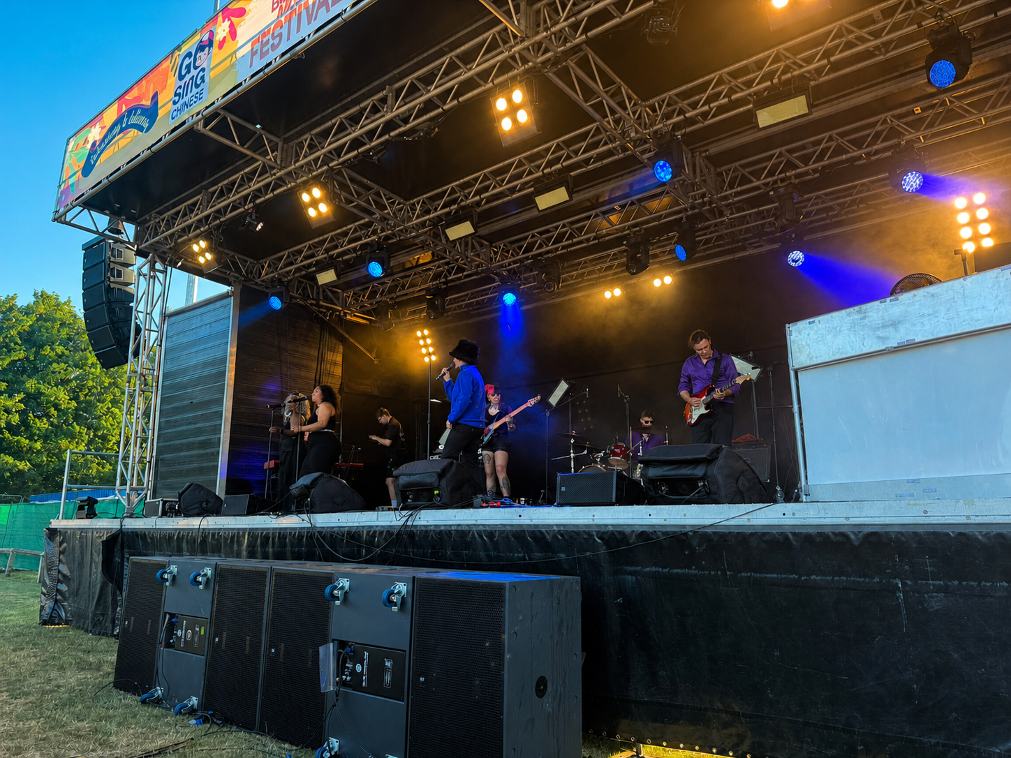 Live band performing on an outdoor festival stage